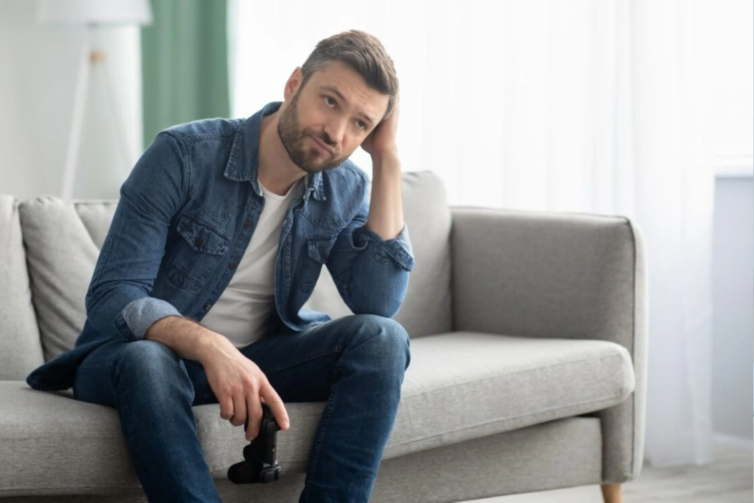 Man with Gaming Addiction Holding Controller