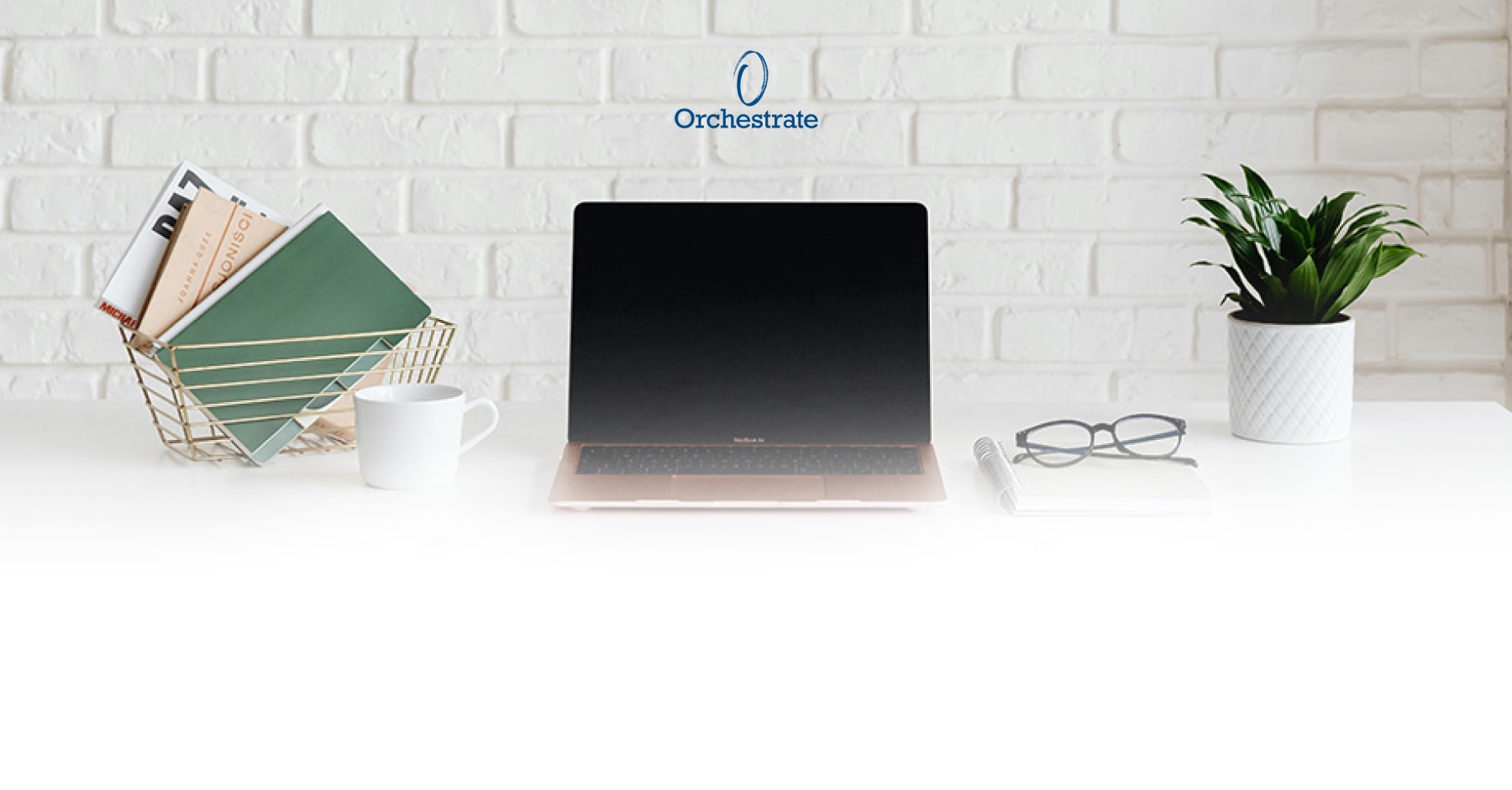 Laptop on table with orchestrate logo in background
