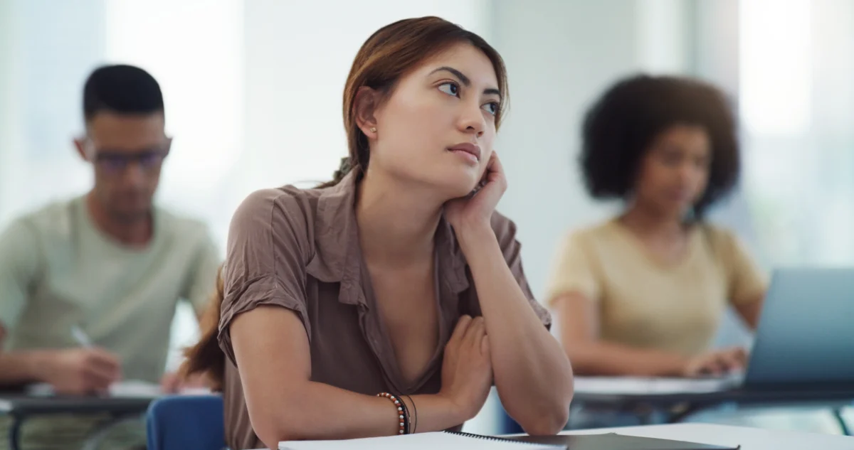 a woman trying to focus in a classroom